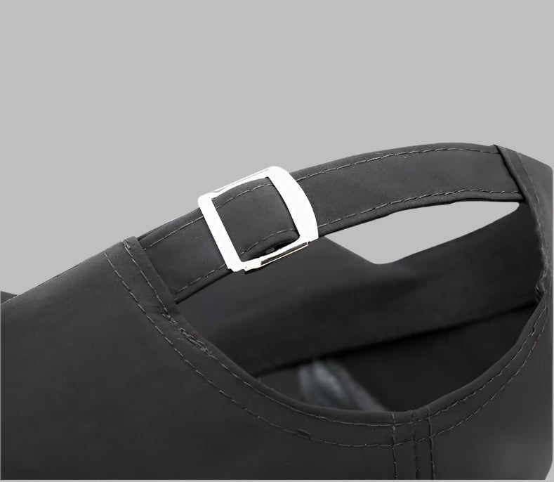 Black cap with a silver buckle on a light blue background