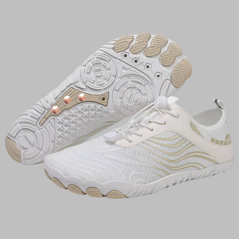 White athletic shoes with beige accents on a white background