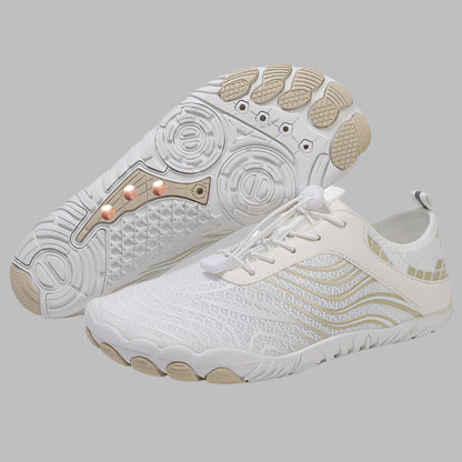White athletic shoes with beige accents on a white background