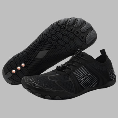 Black athletic shoes with textured soles on a white background