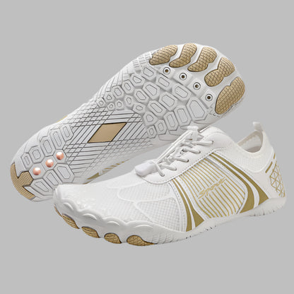 White and gold athletic shoes on a white background