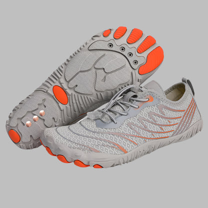 Gray sneakers with orange accents on a white background