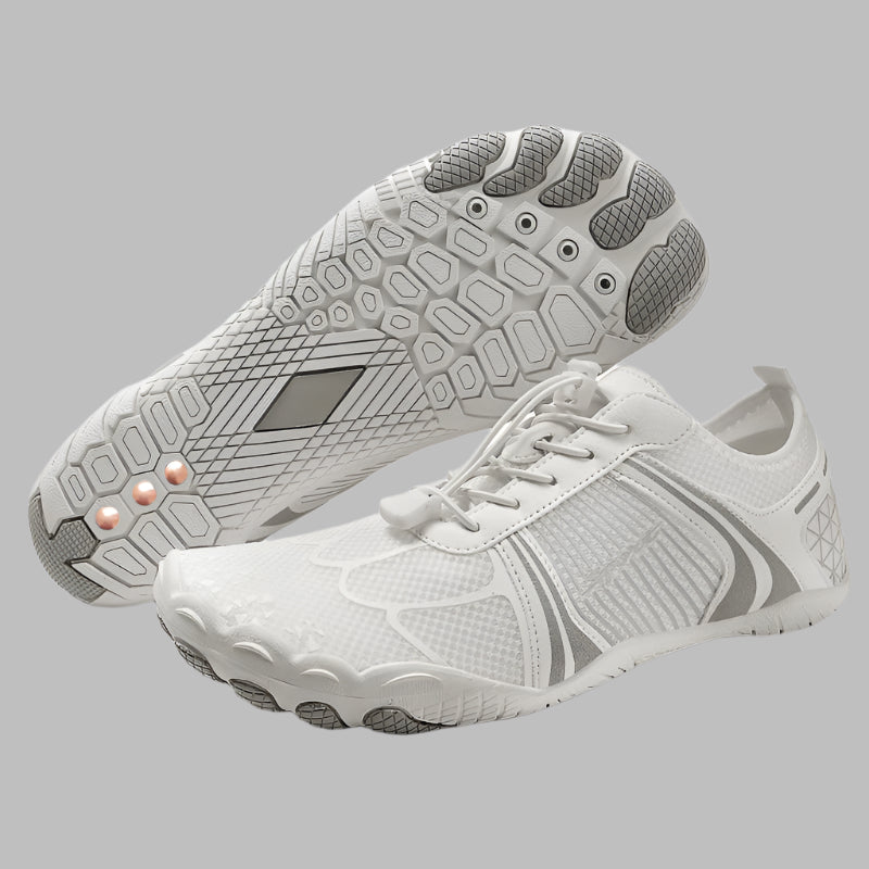 White athletic shoes with gray soles on a white background