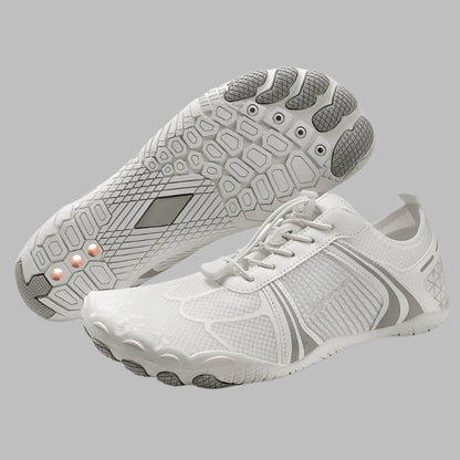 White athletic shoes with gray soles on a white background