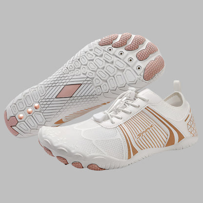 White and rose gold athletic shoes on a white background