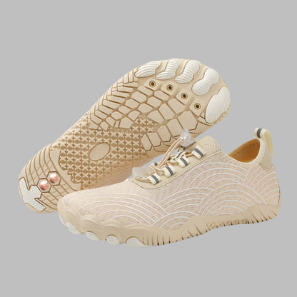 Beige sneakers with textured soles on a white background