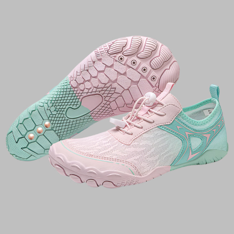 Pink and teal running shoes on a white background